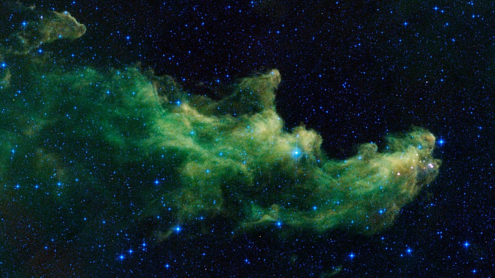 Green infrared cloud of the Witch Head Nebula IC 2118 shaped like a face in profile against a star field. Image: NASA/JPL-Caltech (WISE), public domain, cropped and rotated