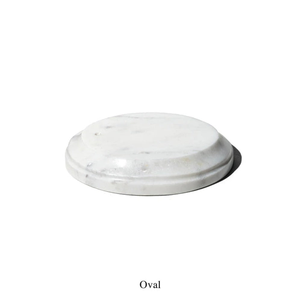 Oval white marble incense holder with a stepped edge detail, shown on white