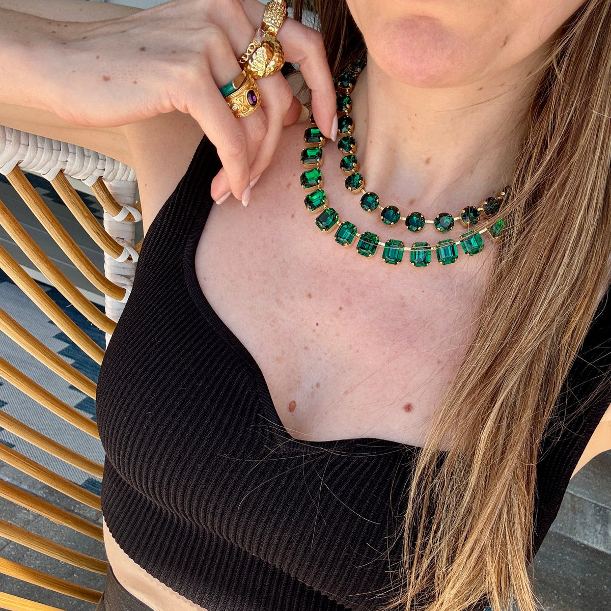 The green emerald-cut necklace worn with a second finer green strand and a gold ring; this listing is the emerald-cut necklace only.