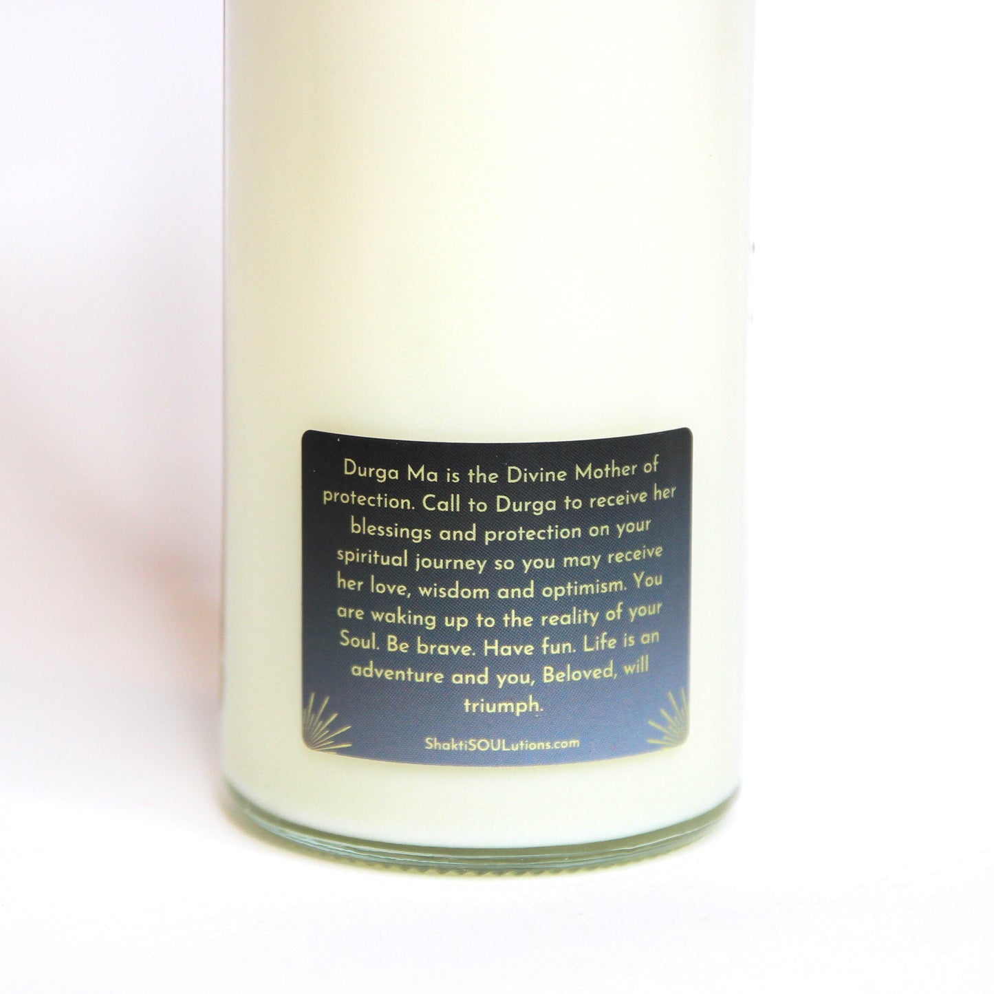 The Durga altar candle styled on a dark altar surface