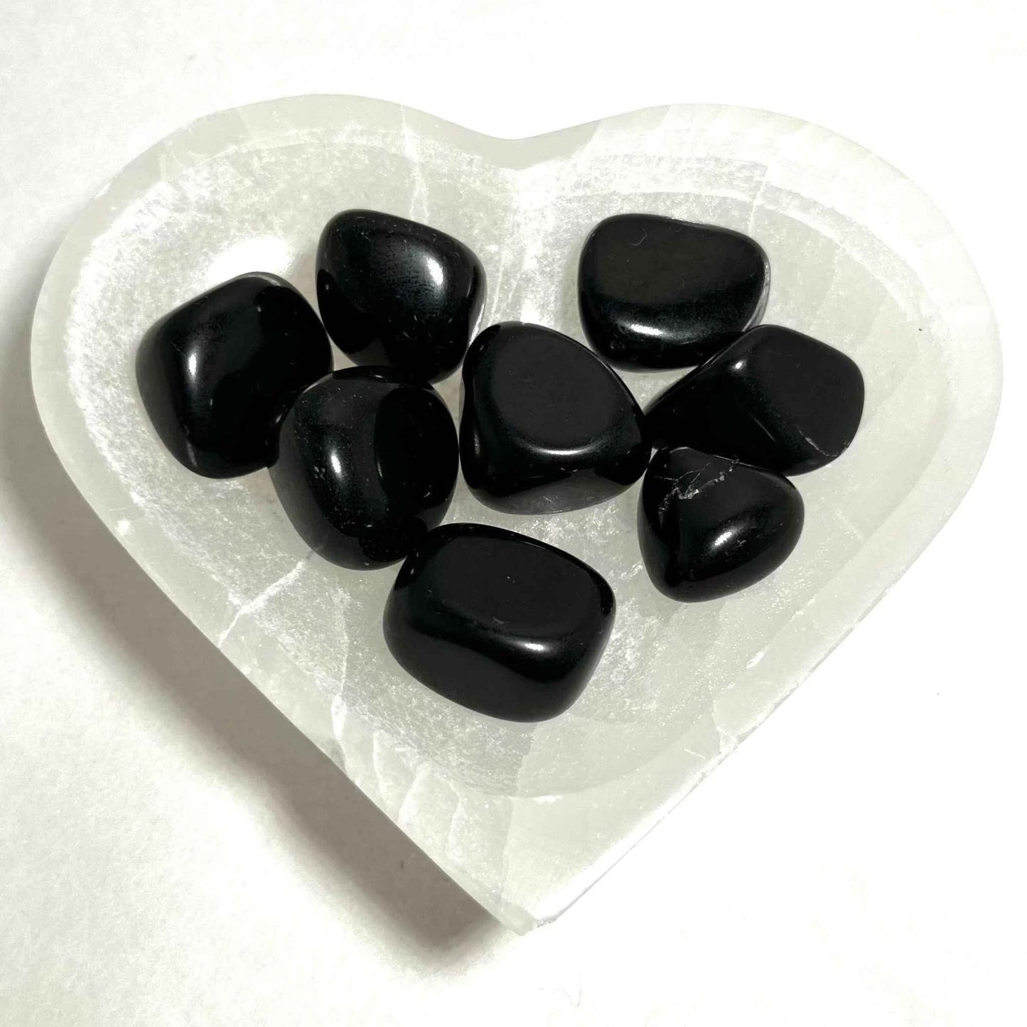 Black Obsidian pocket stone held to show its palm-friendly size