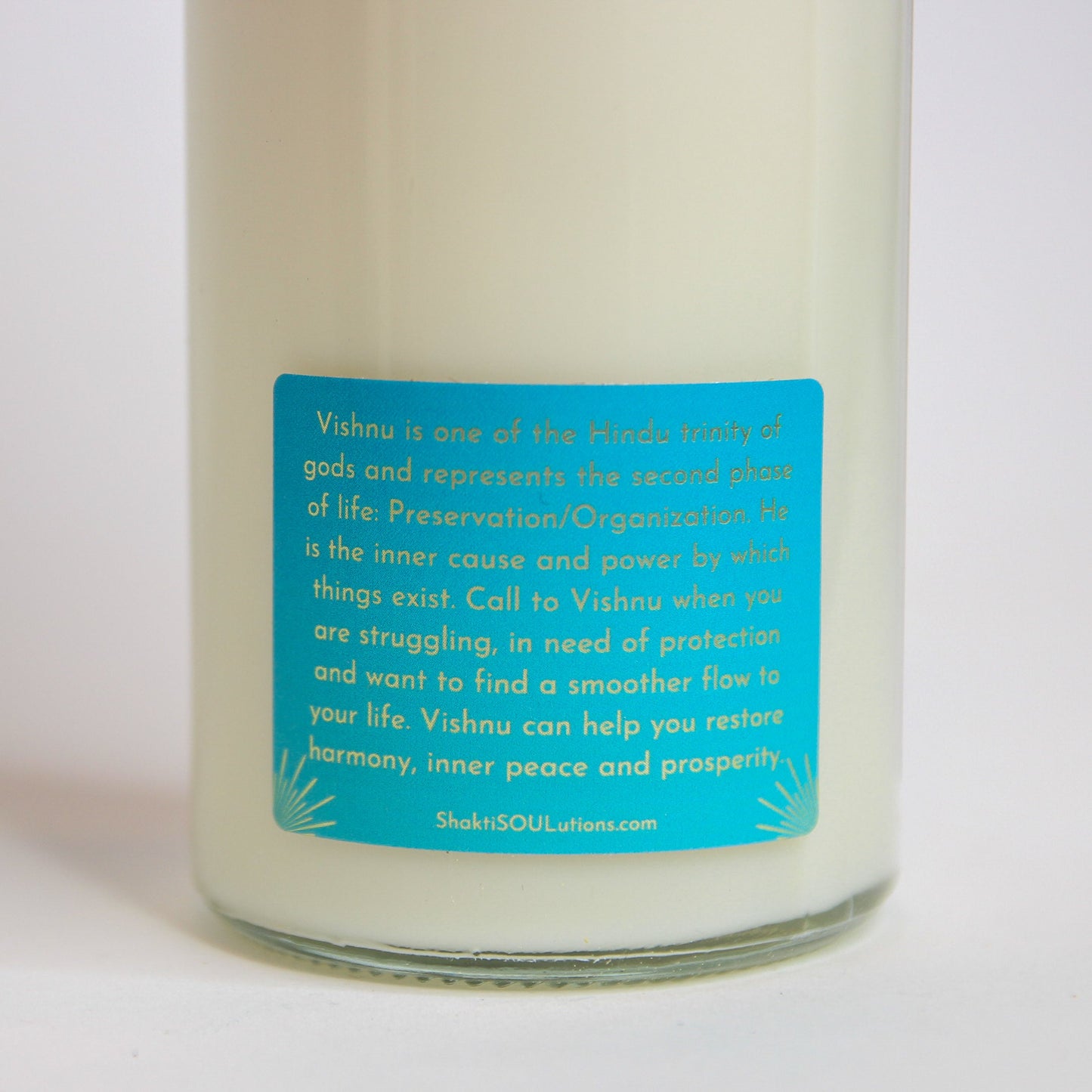 The Vishnu altar candle styled on a dark altar surface