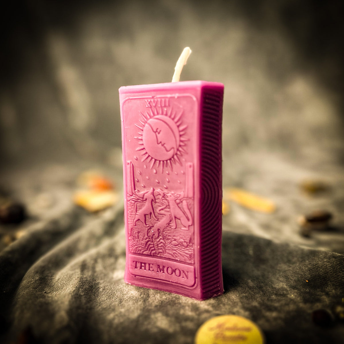 Magenta pink beeswax The Moon tarot card candle with the numeral XVIII at the top