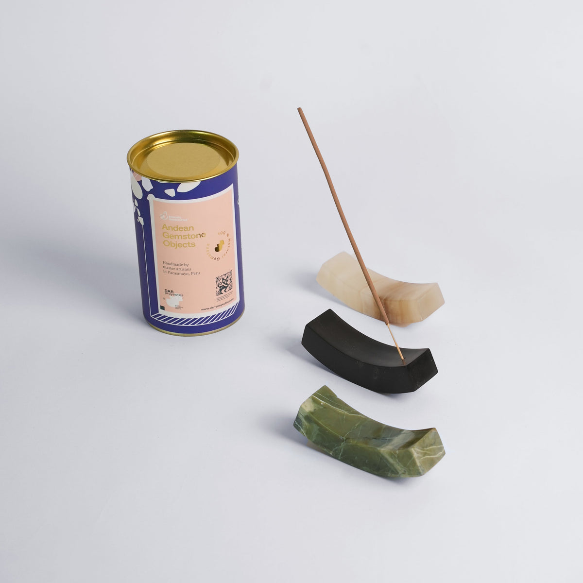 Curve incense holders in three stones shown together with an incense stick in place