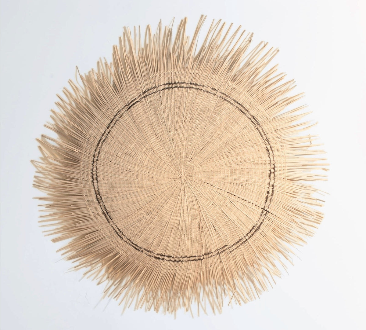 Sun Circle disc seen close, showing the woven fiber center and dark banding