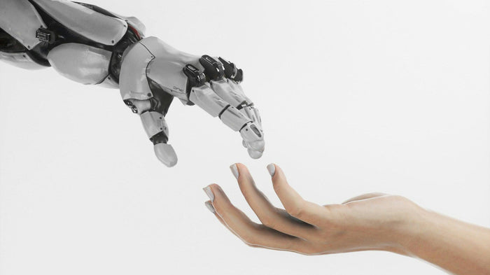 A robotic hand and a human hand reaching toward each other against a plain white background