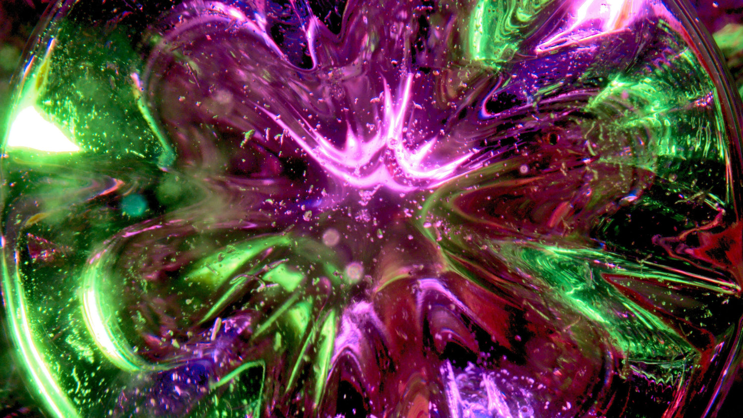 Swirling field of magenta, green and violet light, the way aura colors are often described