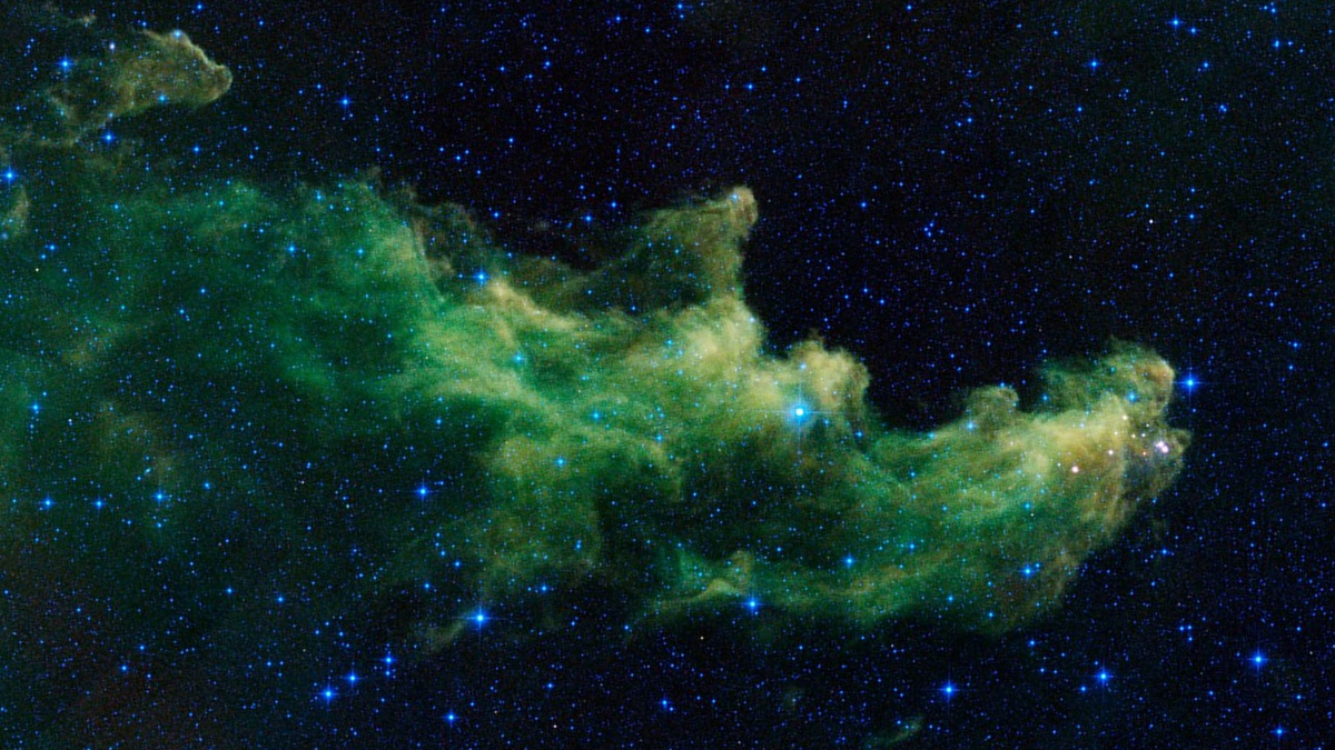 Green infrared cloud of the Witch Head Nebula IC 2118 shaped like a face in profile against a star field. Image: NASA/JPL-Caltech (WISE), public domain, cropped and rotated