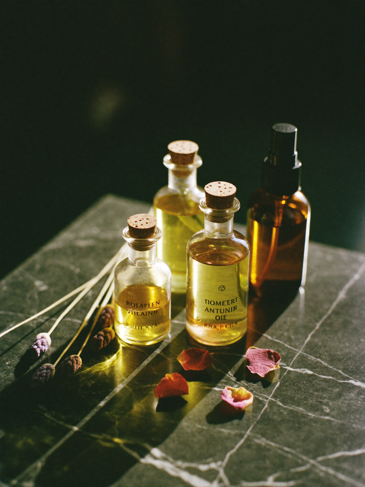 Apothecary bottles of ritual anointing oil in candlelight