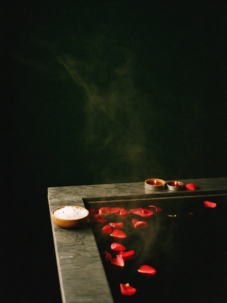 Ritual bath with rose petals, bath salts and candles