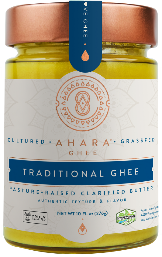 A glass jar of Ahara Rasa Traditional cultured grass-fed ghee with a copper lid and dark blue label band.