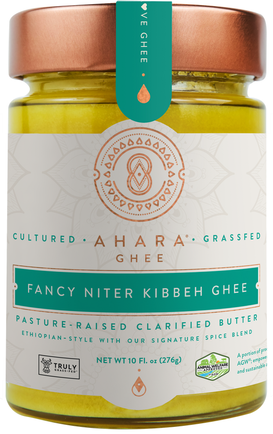 A glass jar of Ahara Rasa Fancy Niter Kibbeh spiced grass-fed ghee with a copper lid and teal label band.