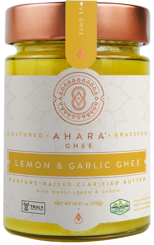 A glass jar of Ahara Rasa Lemon & Garlic cultured grass-fed ghee with a copper lid and yellow label band.