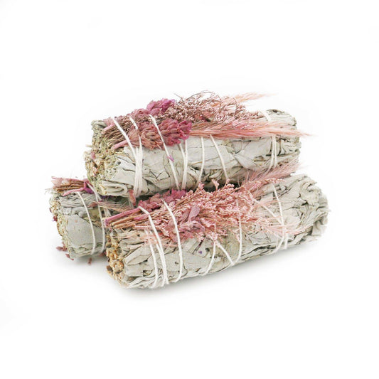 White sage smudge stick wrapped with a bouquet of pink dried flowers, front view