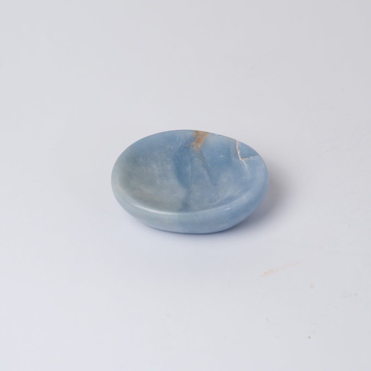 Pale blue angelite dish with an organic outline, shown on a white background