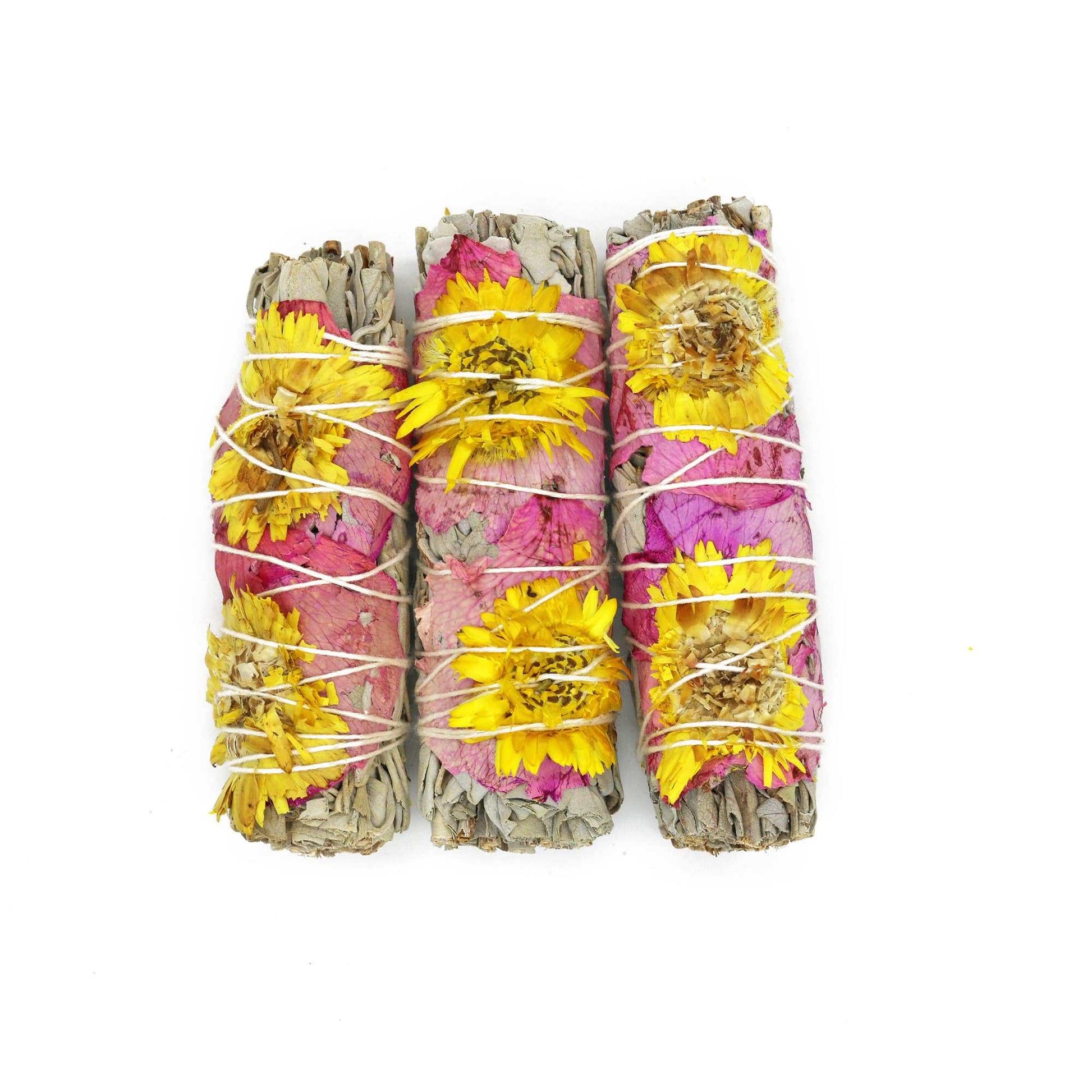 Four-inch Amor floral white sage smudge stick against a plain background
