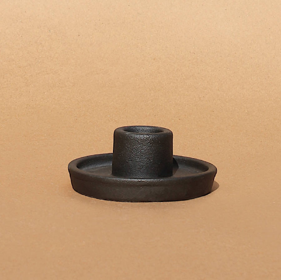 Black Whirl candle holder from the side, showing the wide dish base