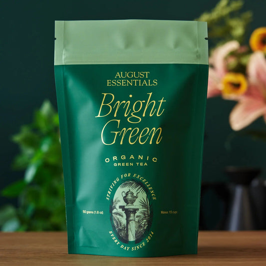A green August Essentials stand-up pouch of Bright Green organic loose leaf green tea.