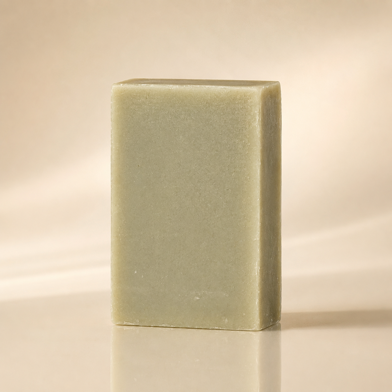 Bamboo and bentonite mud bar, deep charcoal-grey soap with a matte surface