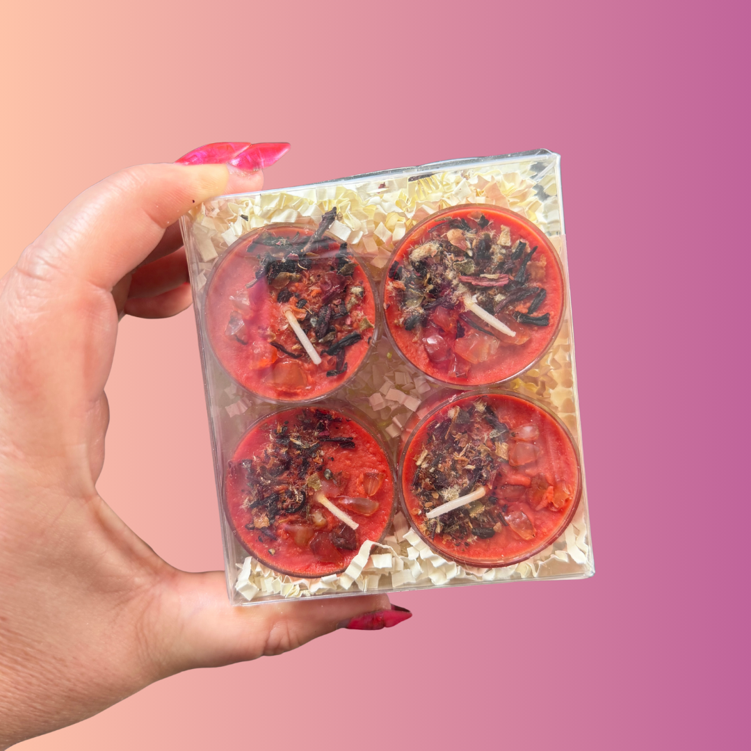 Close-up of a Shakti tealight showing the dried botanicals and carnelian chips on the wax.