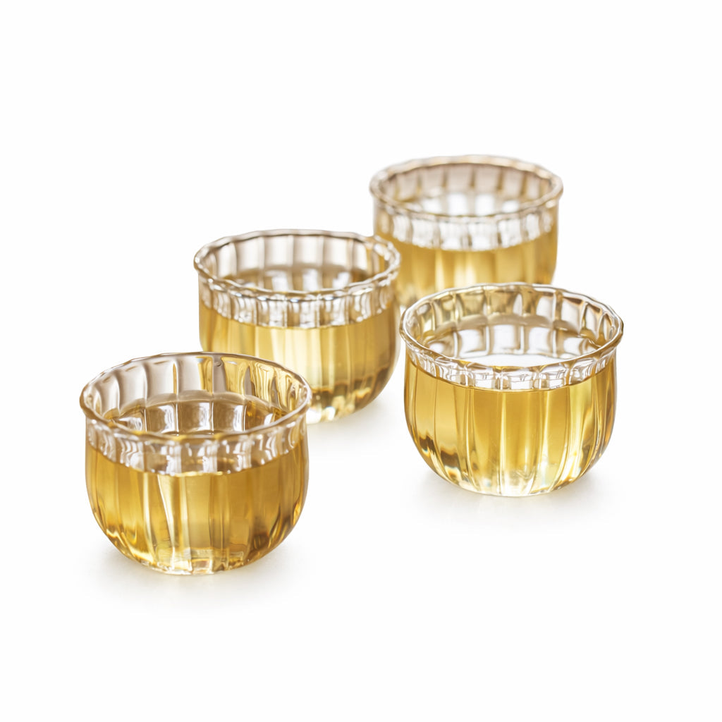 Set of four Kira glass cups on white, showing the ribbed bud shape