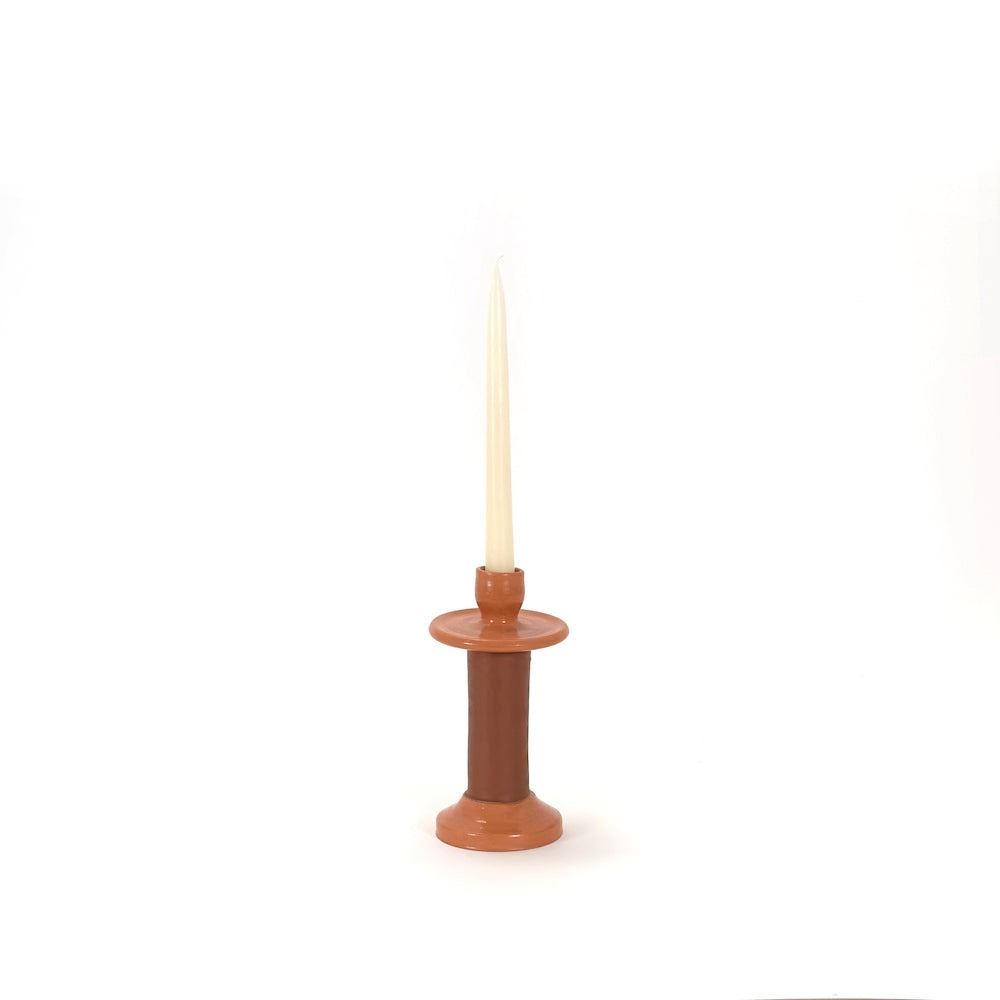Small terracotta leather-wrapped candle holder seen from the front