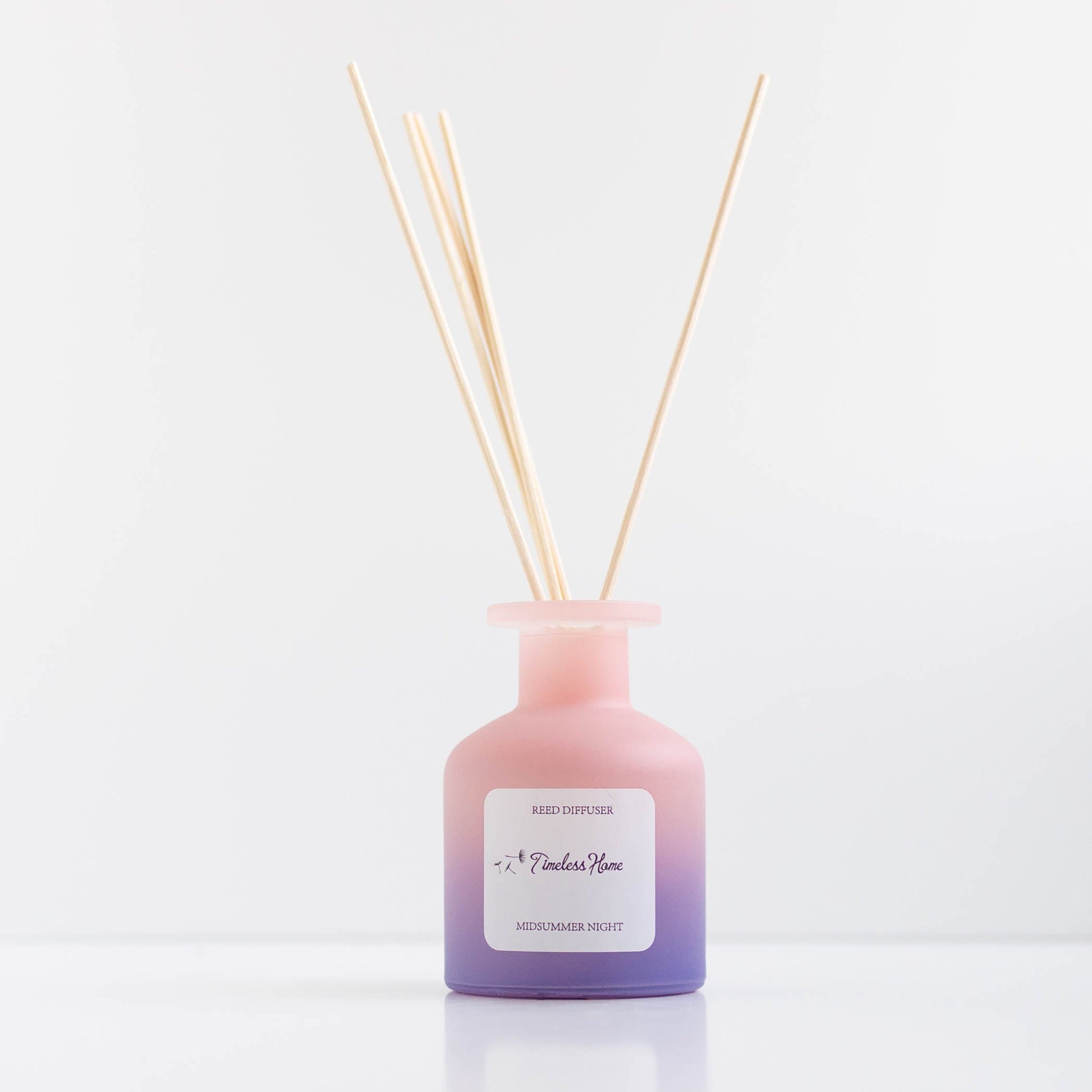 Midsummer Night reed diffuser in a frosted glass vessel with five natural reed sticks