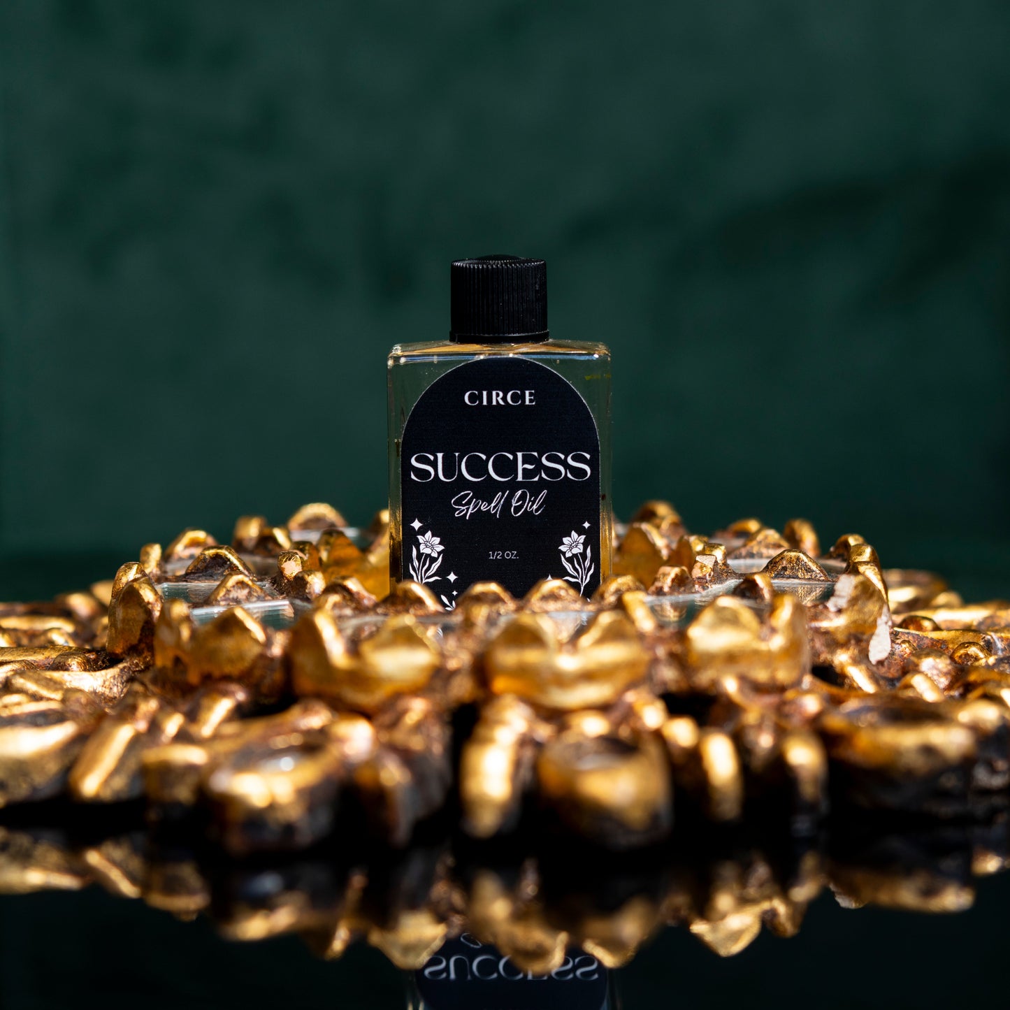 Success ritual oil in a small twist-top glass bottle with ginger root (view 2)