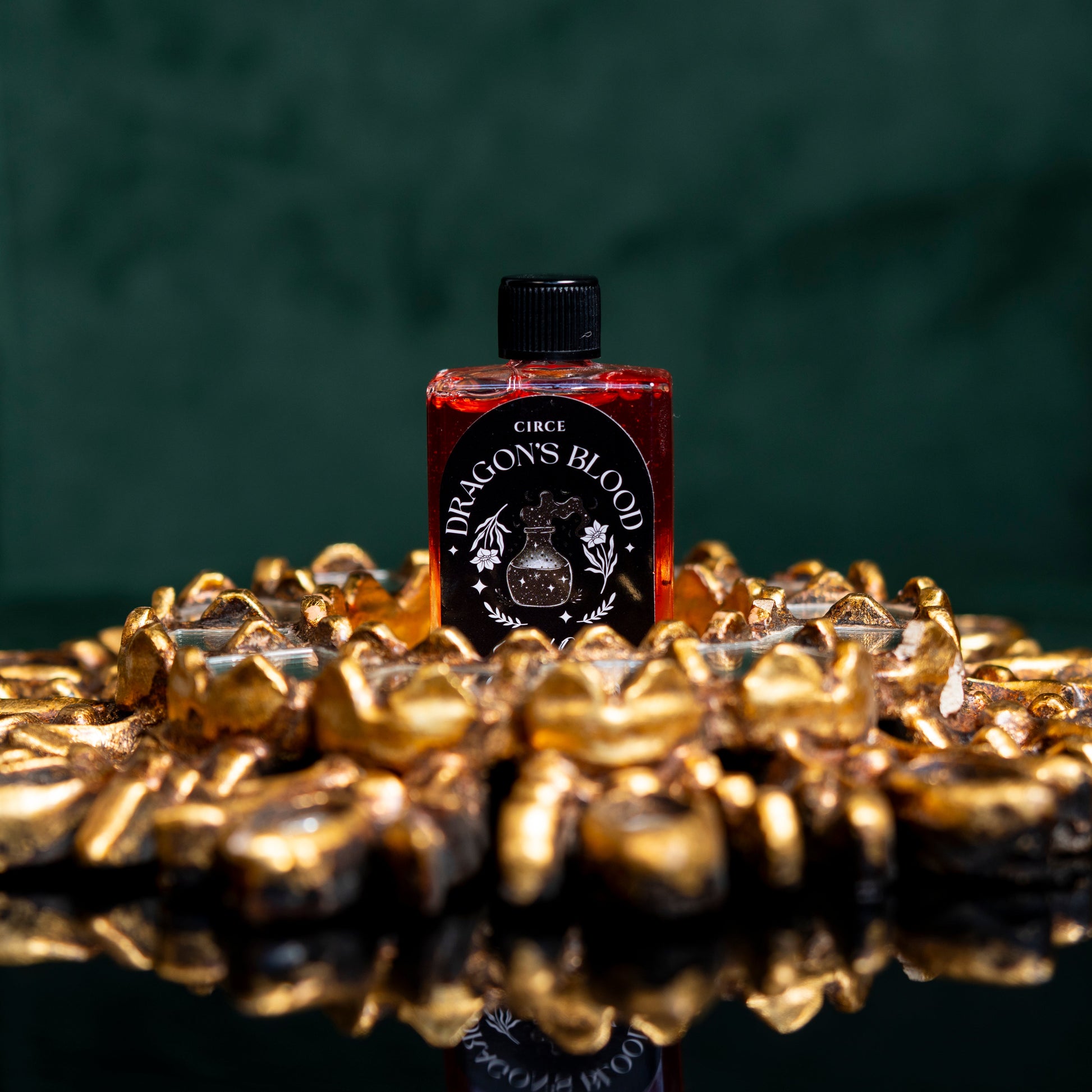 Dragon's Blood ritual oil in a half ounce twist-top glass bottle with resin (view 4)