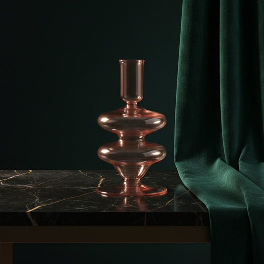 Pink glass Siri candle holder on dark marble against green velvet