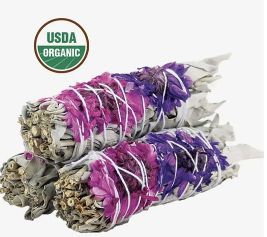 Four-inch white sage smudge stick decorated with dried fuchsia, purple, and pink flowers
