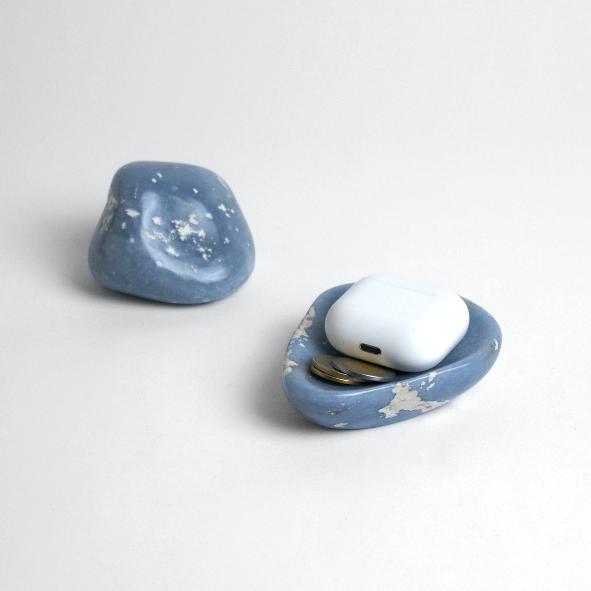 Angelite dish holding earbuds and coins beside a matching angelite stone