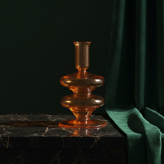 Amber glass Gigi candle holder on dark marble against green velvet
