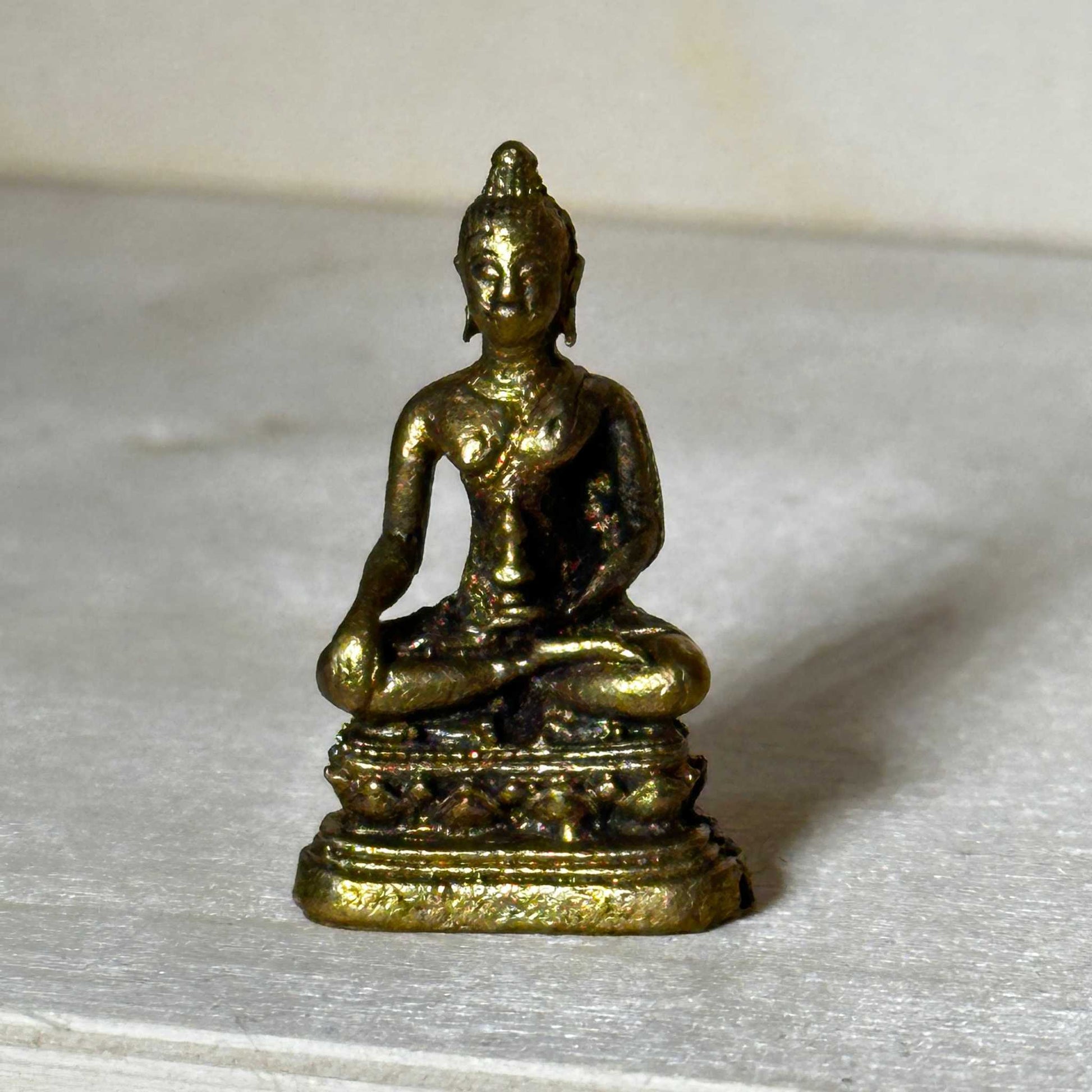 Small brass statue figurine sized to fit in the palm of a hand, alternate view
