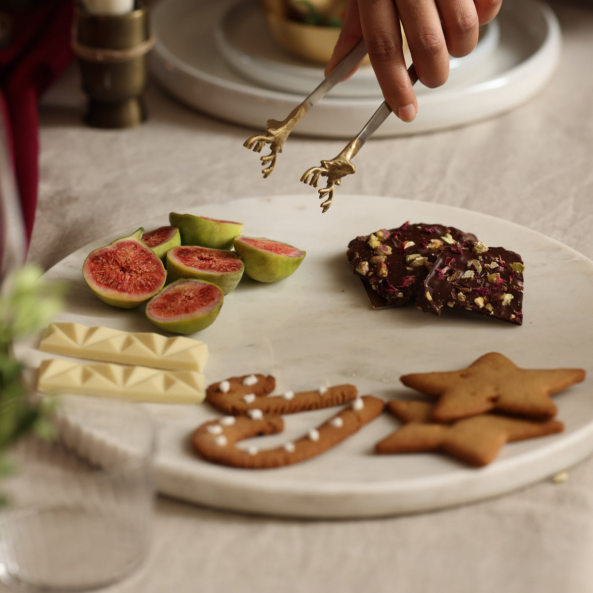 White marble platter being served from, with figs, gingerbread and white chocolate
