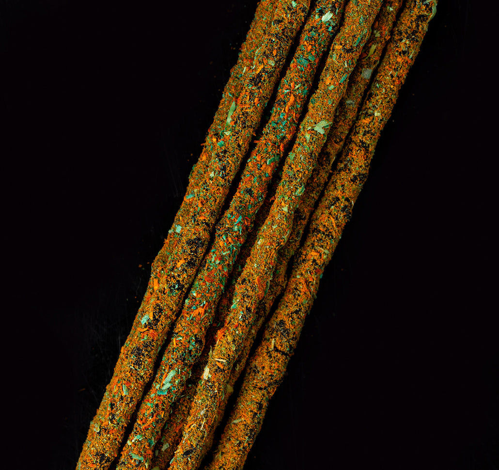 Close-up of hand-rolled Venus Cosmos sticks flecked with green and gold