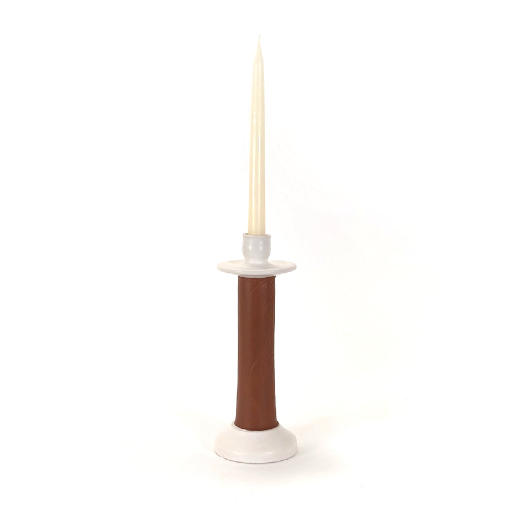 Medium brown leather-wrapped candle holder with a cream taper candle