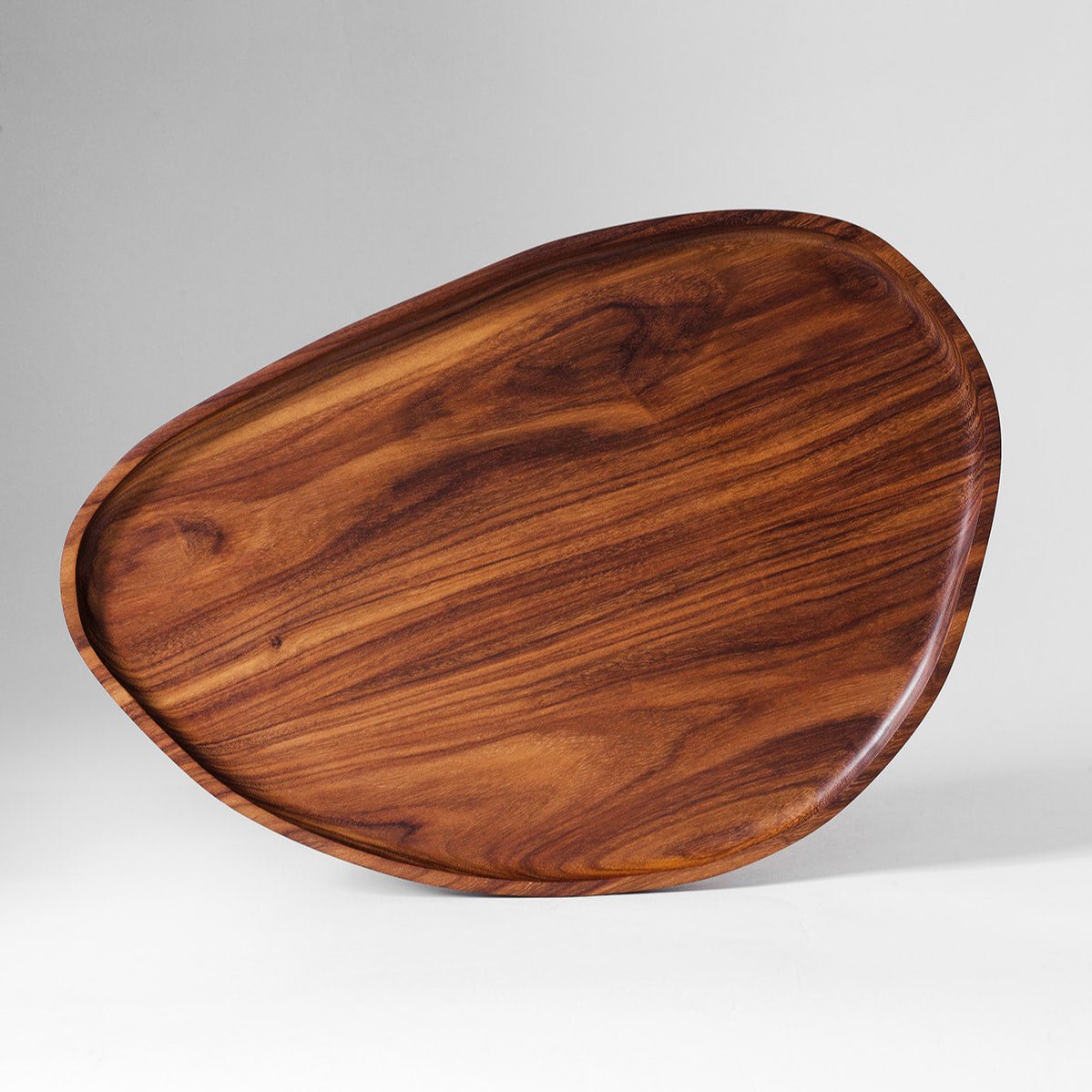 Large granadillo leaf tray showing the carved hollow and deep hardwood grain