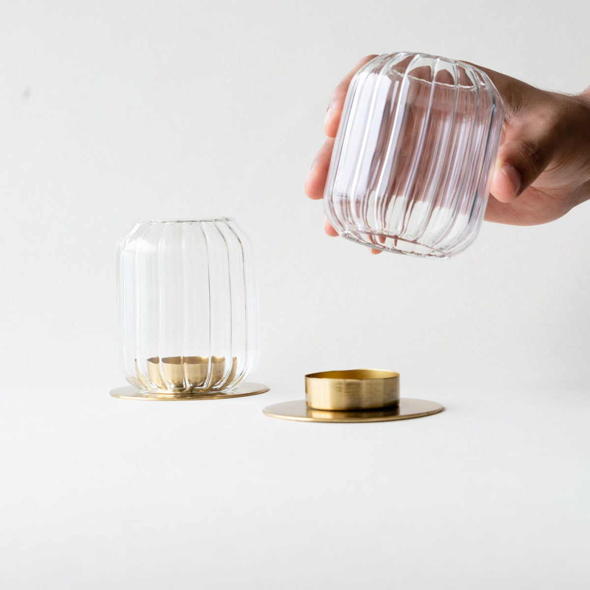 Kira lantern shade lifted off the brass base to reach the tealight