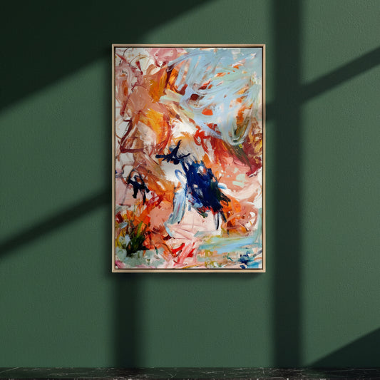 Dream Big framed canvas print hanging on a dark green wall in raking light