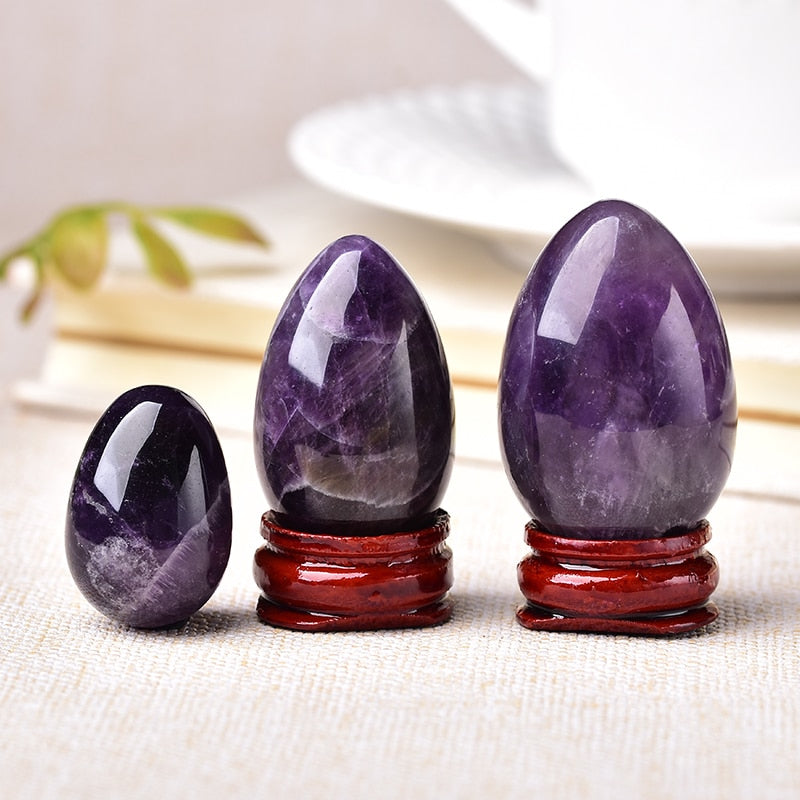 Polished carved crystal egg in assorted gemstones on a dark surface — view 4 of 10