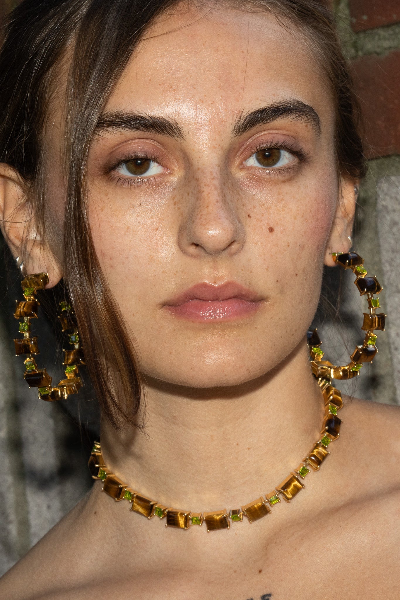 A gold-plated Battlement choker set with genuine tiger eye stones and bright green glass crystals.