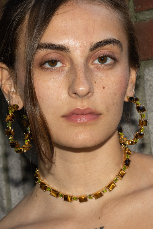 A gold-plated Battlement choker set with genuine tiger eye stones and bright green glass crystals.