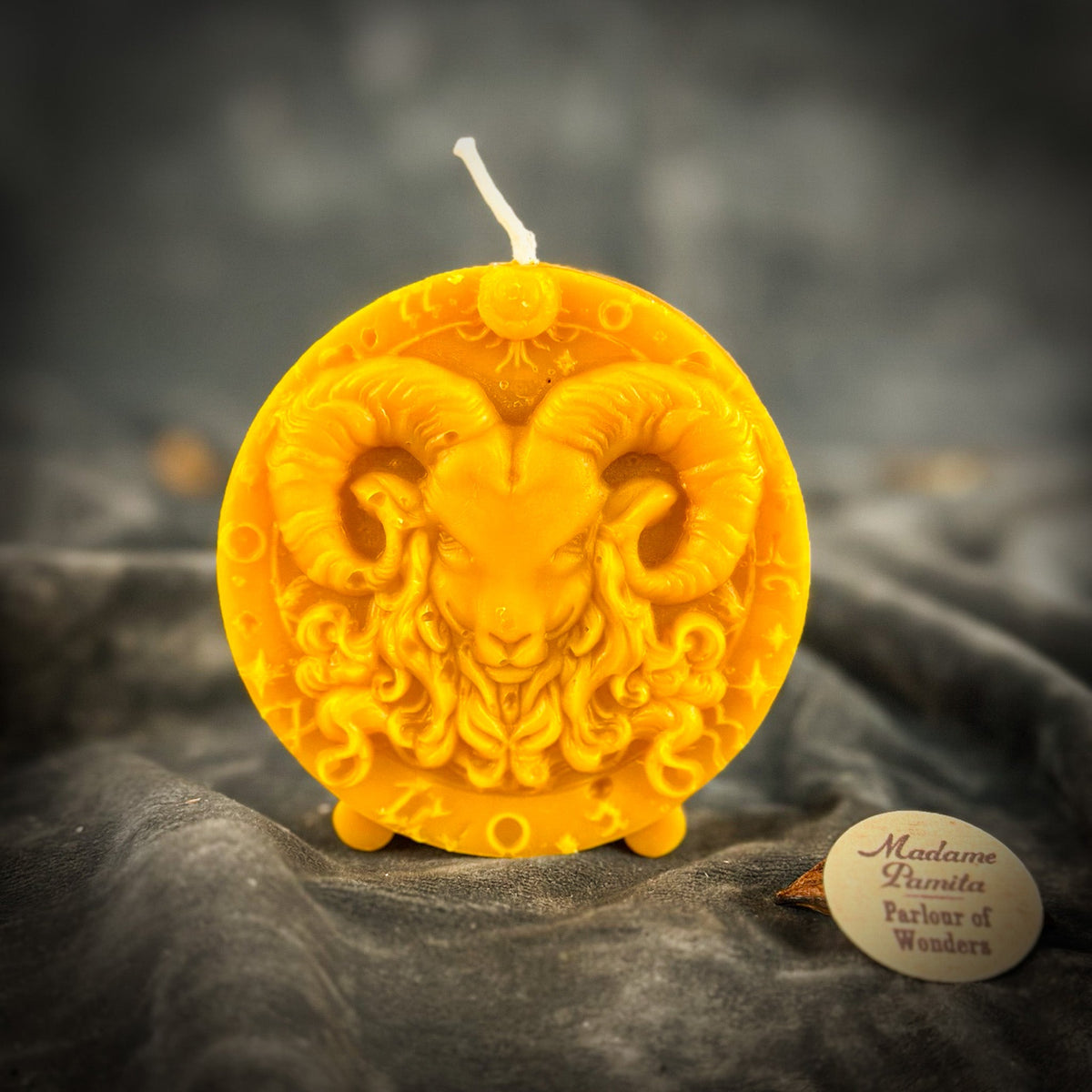 Amber-yellow Aries medallion candle, the most translucent of the colors.