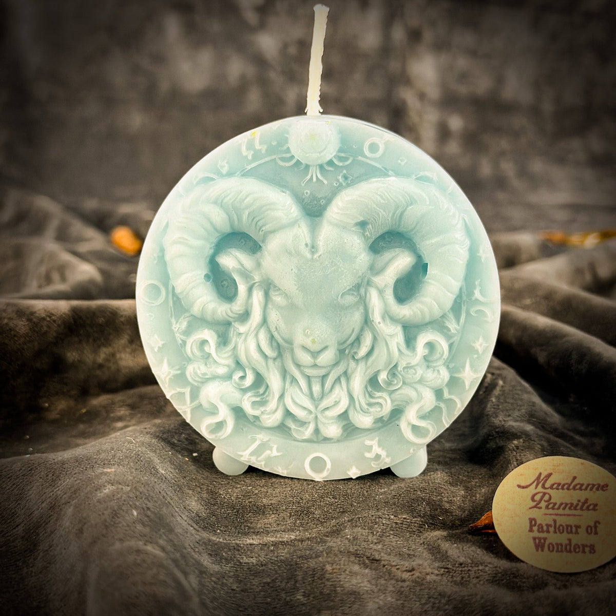 Pale blue Aries medallion candle, the ram's fleece and horns softly molded.