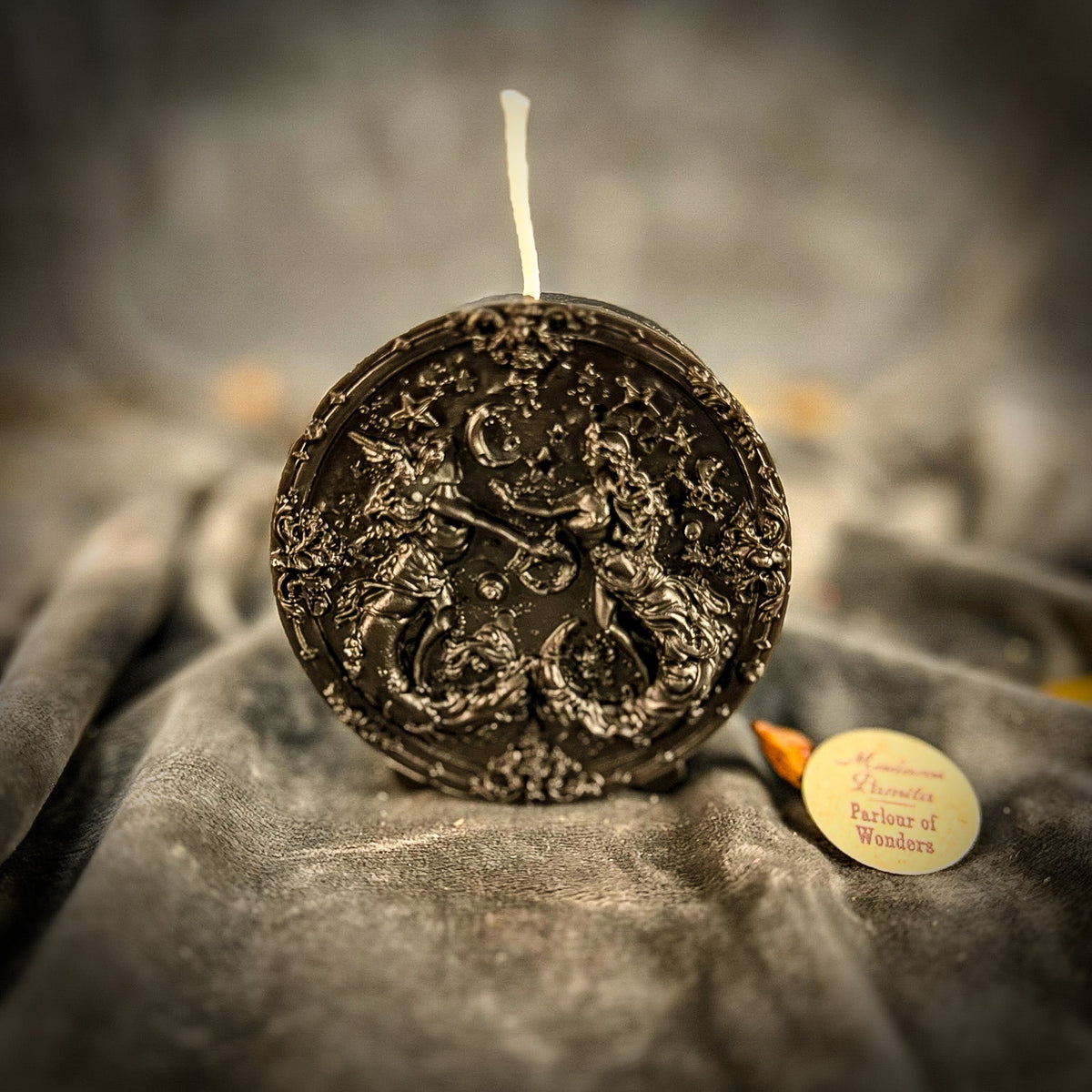 Black Gemini medallion candle, the whole design showing only as highlights.