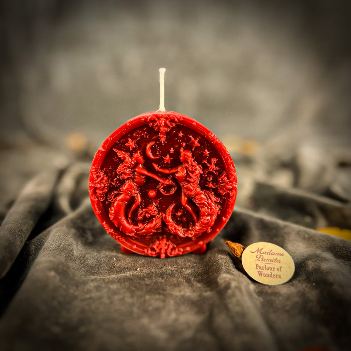 Red Gemini medallion candle, the deepest relief of the range.
