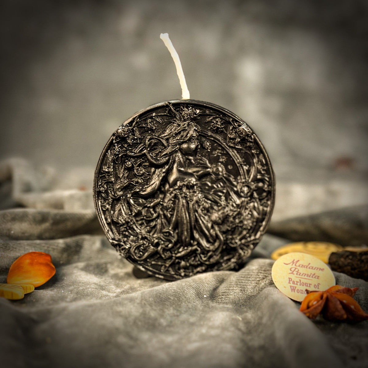 Libra Scales zodiac spell candle in black on draped gray fabric