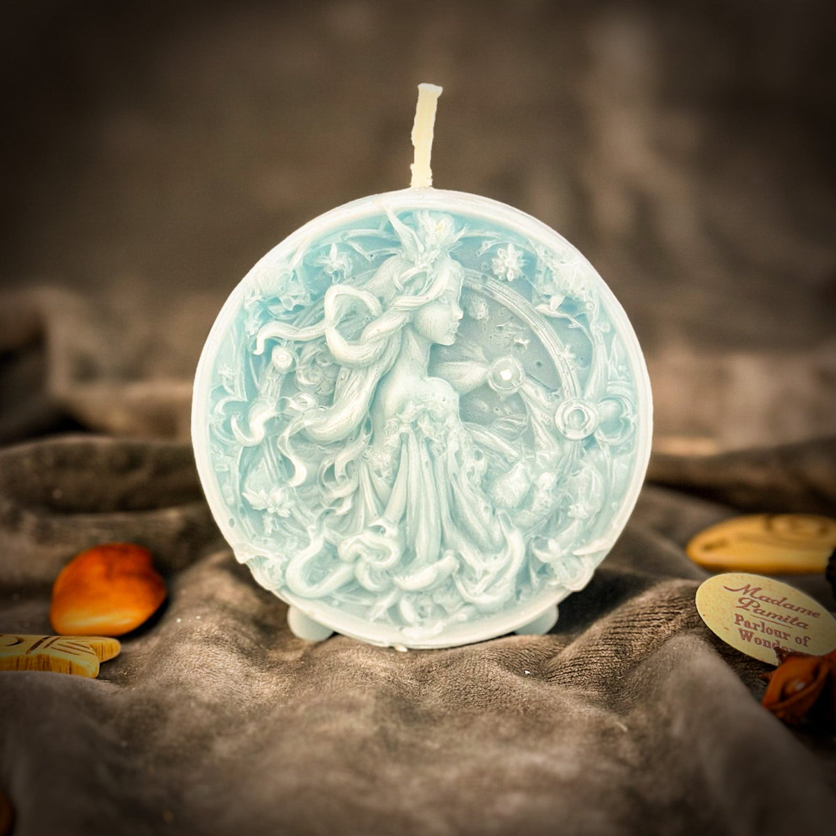 Libra Scales zodiac spell candle in pale blue on draped gray fabric
