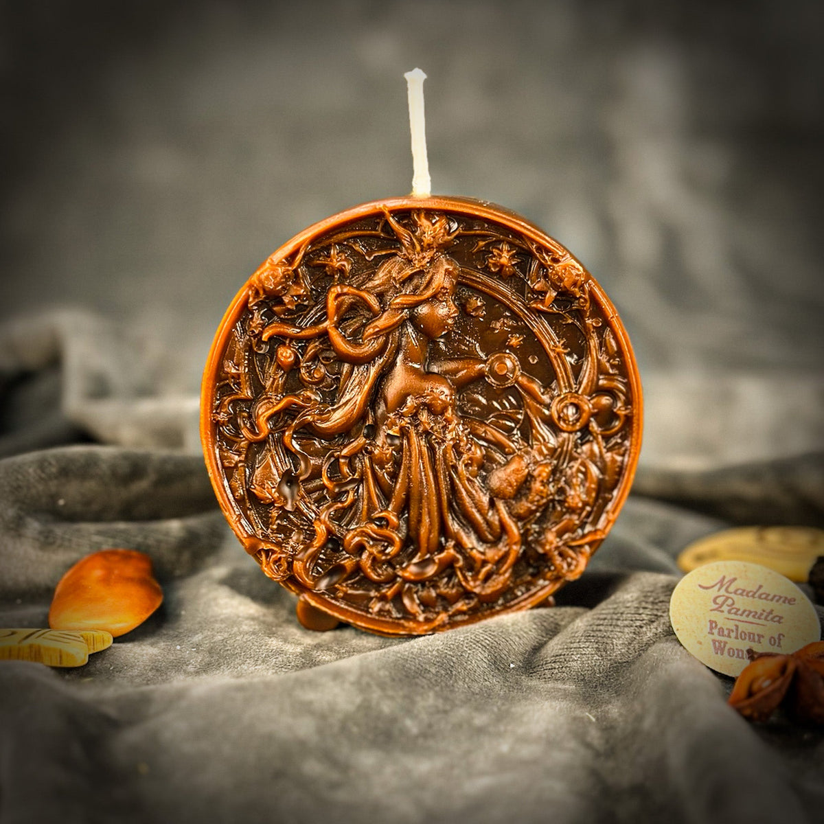 Libra Scales zodiac spell candle in brown on draped gray fabric